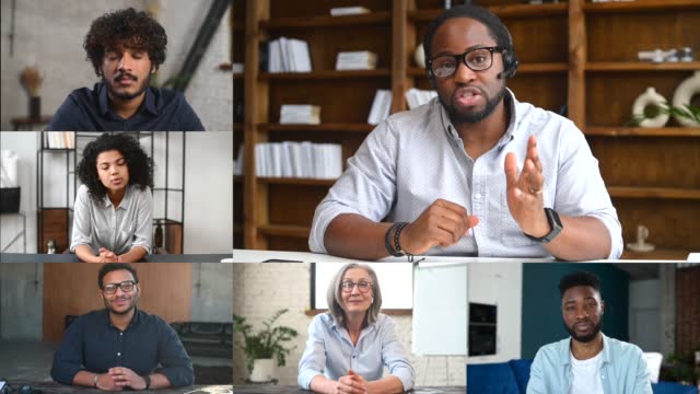 Smiling African businessman, tutor talking to diverse people on conference video call