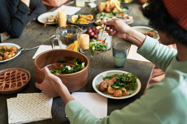 istock Boy eating salad at family dinner 1392311488
