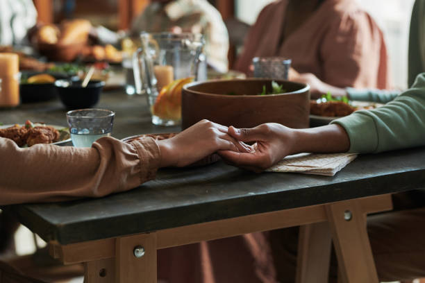 istock Family praying at dining table 1392311609