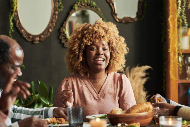 istock Happy woman having dinner with family 1392313183