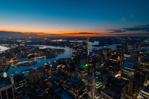 Sydney at night Sydney, Australia - April 16, 2022: Aerial view of Sydney CBD at dusk. sydney skyline sunset stock pictures, royalty-free photos & images