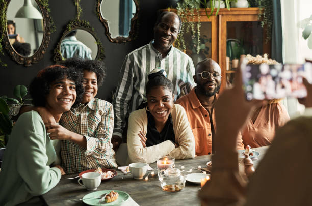 istock Big family posing to camera at table 1392313567