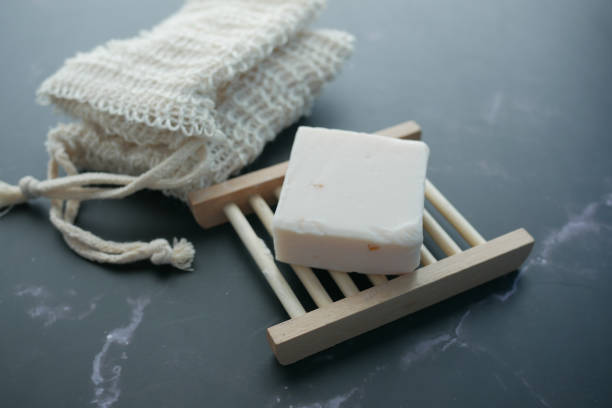 istock Homemade natural soap bar on black background 1392313704