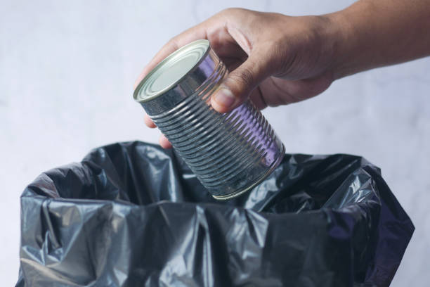 istock throwing food tin in a garbage bin 1392315351
