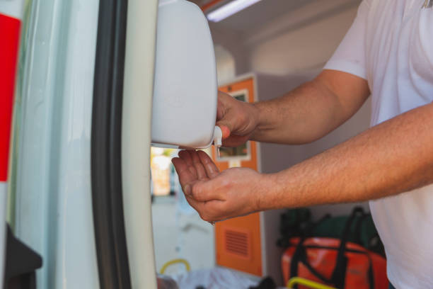 istock Ambulance staff disinfections his hands 1392315583