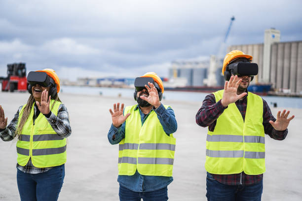 istock Multiracial workers using virtual reality headsets at industrial terminal Port - Focus on right man goggles 1392315993