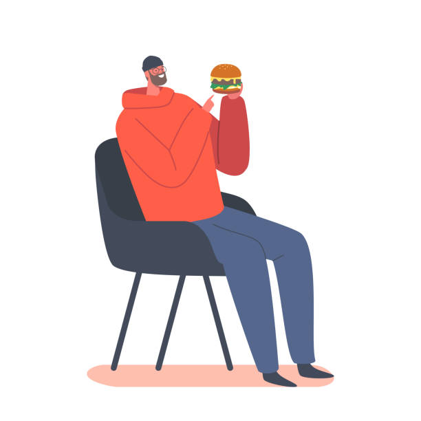 하얀 배경에 고립된 손에 패스트푸드 버거를 들고 의자에 앉아 있는 쾌활한 남자. 패스트 푸드 식습관 - bad habit illustrations stock illustrations