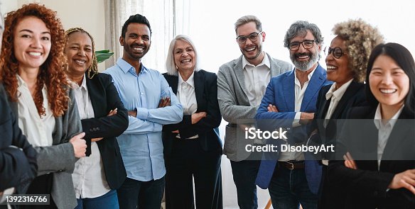istock Multiracial business people looking at camera inside bank office - Focus on indian man face 1392316766
