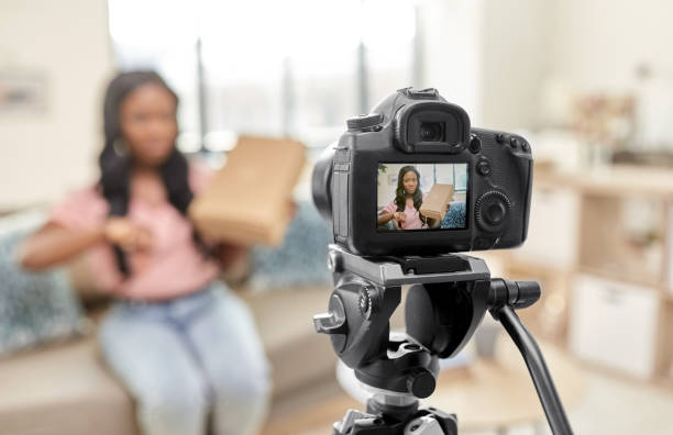 istock female video blogger with camera and box at home 1392317029