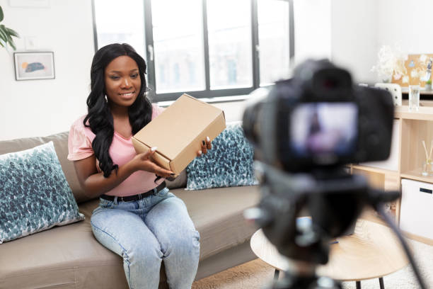 istock female video blogger with camera and box at home 1392317420