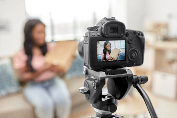 istock female video blogger with camera and box at home 1392317618