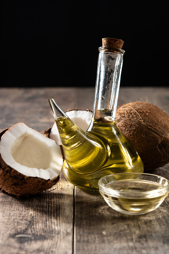 Coconut oil in crystal bottle on wooden table