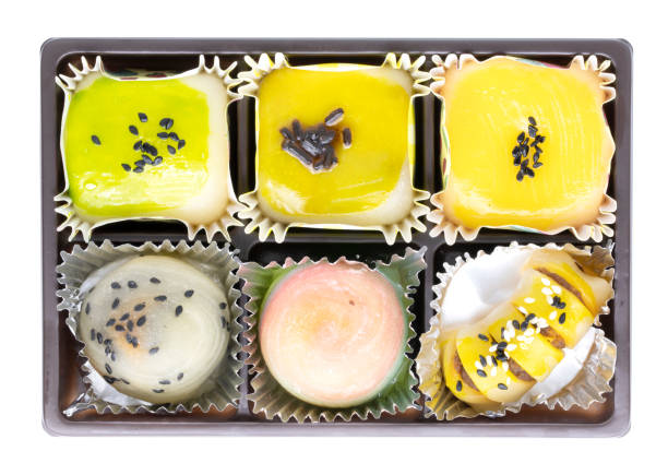 istock Colorful dessert with black sesame in brown tray isolated on white background 1392319085