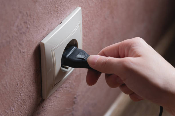 istock A female hand inserts an electric plug into a euro-format socket close-up 1392320992
