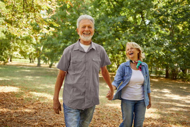 istock Happy senior couple going for a walk in the park 1392321966