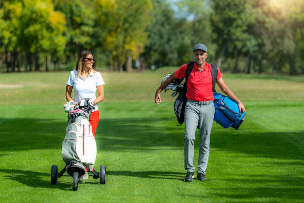 istock Golfing couple enjoying a game on a golf course 1392322430