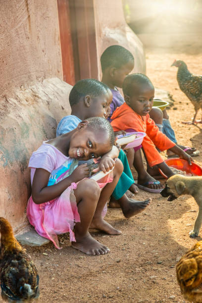 african kids in the village eating stock photo