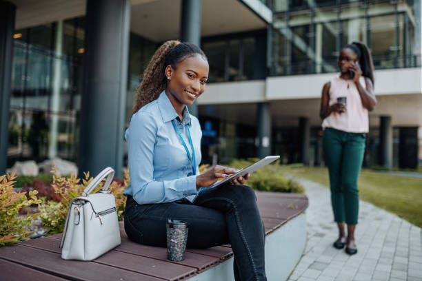 istock African American business people in financial district, talking or using mobile device during coffee break near corporate building 1392325962