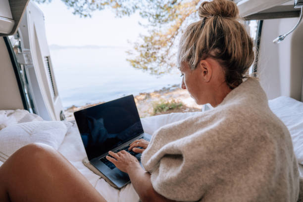 istock Woman working online from her Campervan 1392326743