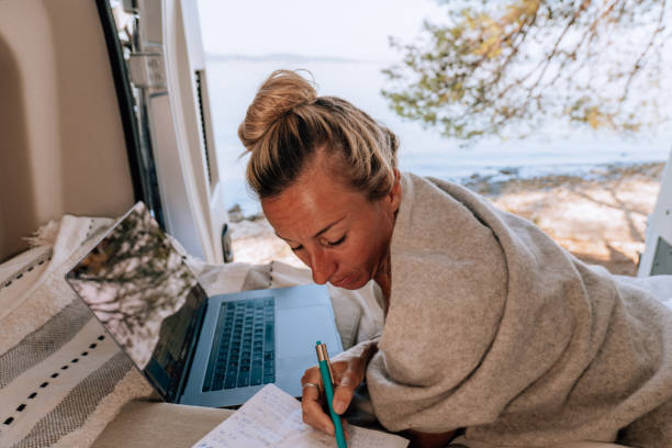 istock Woman working online from her Campervan 1392326885