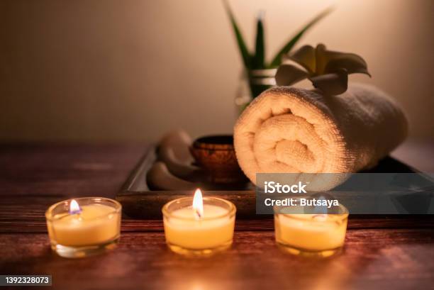 Close Up Wooden Gun Sha Rolled Towel Stone Flower And Candle On The Tray Over Wooden Background Facial Spa Set Wellness Wellbeing Lifestyle Concept Stock Photo - Download Image Now