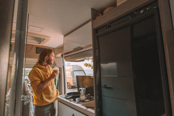 istock Man drinks coffee in his van, sea view 1392328240