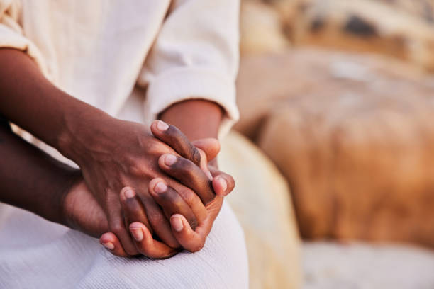 istock Young couple holding hands while sitting on a beach 1392328518