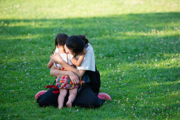 Mother hugging her daughter in the field