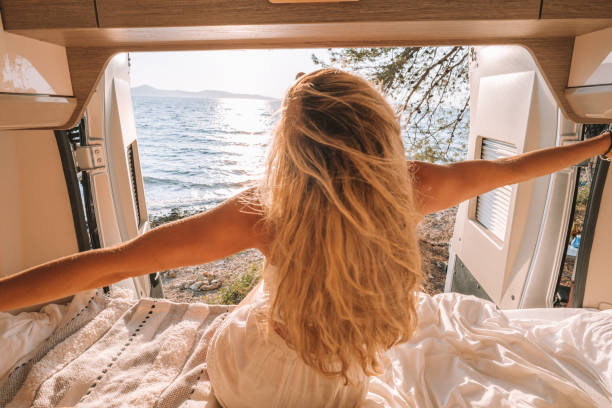 istock Woman in her van stretching arms out 1392328695