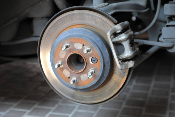 istock Disk brake and caliper in process of new tire replacement 1392328853