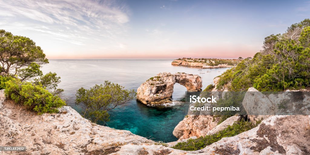 Es Pontas natural stone arch in the sea Es Pontàs ("The big bridge") is a natural arch in the southeastern part of the island of Mallorca. The arch is located on the coastline  of Cala Santanyí Majorca Stock Photo