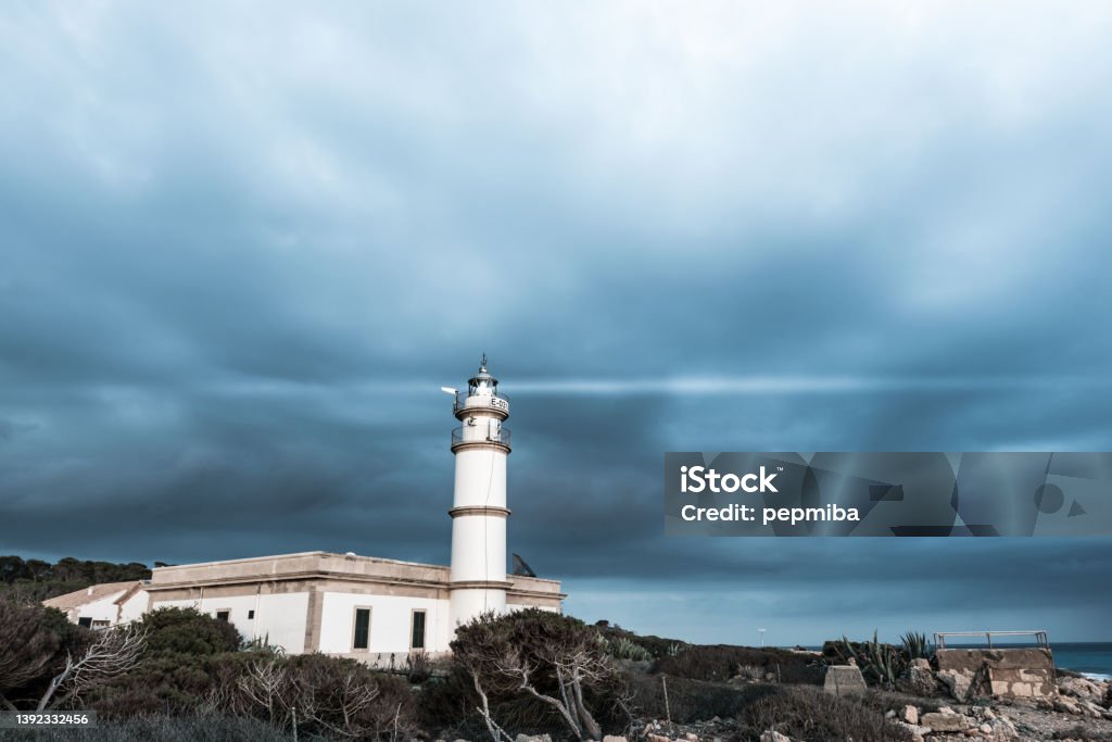Cap de Ses Salines Lighthouse Cap de Ses Saline Lighthouse in stormy day. Majorca, Balearic Islands, Spain Architecture Stock Photo