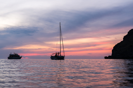 Sailboats in a calm sunset in the mediterranean sea. Majorca, Balearic islands, Spain