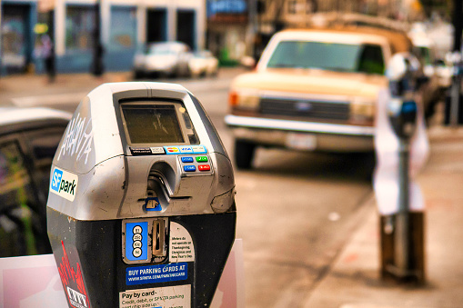 San Francisco, United States - February 13 2020 : an old fashioned parking meter on the street for credit cards and coins