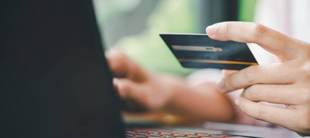 istock Hands holding credit card using laptop Online shopping and paying concept 1392333097