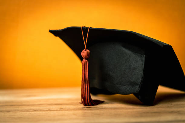 istock Black Graduation Hat placed on wood desk background 1392333098