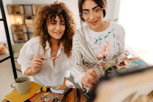 Photo of Female fine artists drawing in studio