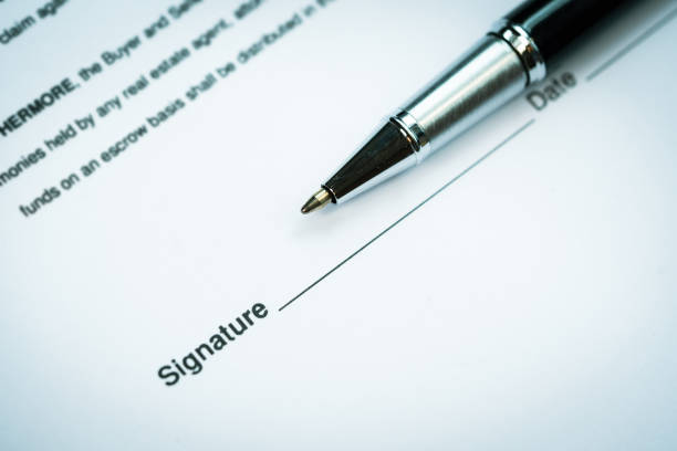 istock Pen and signature on paperwork background to make a contract 1392333214