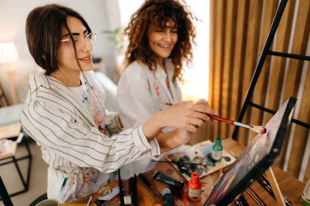 istock Female fine artists drawing in studio 1392333259