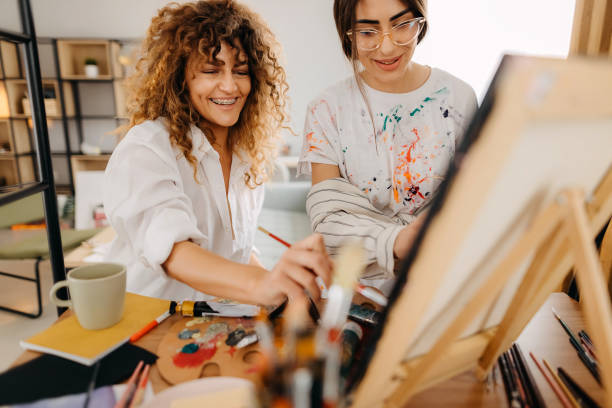 istock Female fine artists drawing in studio 1392333419