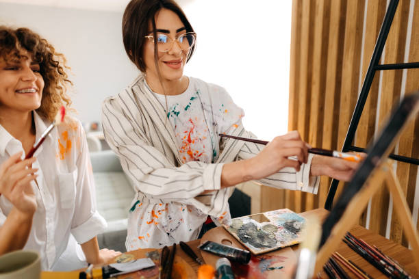 istock Female fine artists drawing in studio 1392333521