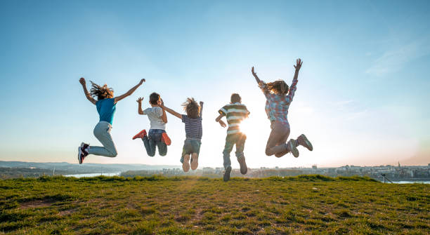istock Happy children jumping 1392333578