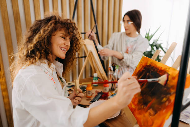 istock Female fine artists drawing in studio 1392333602