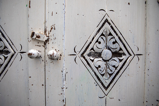 Close up of the doors and handles on a rustic cabinet