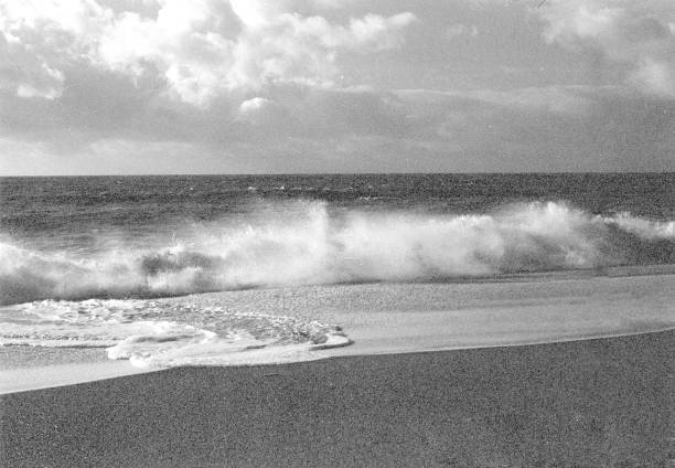 istock Waves splashing onto sandy beach, 35mm. 1392336532