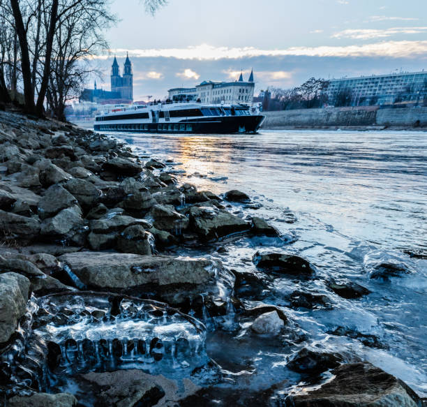 istock Magdeburg skyline with Elbe River and River Cruise Boat at sunset 1392339923