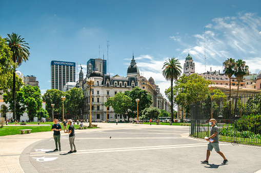 Some people at the Plaza de Mayo in Buenos Aires, capital city of Argentina. People are walking, Sunny weather.