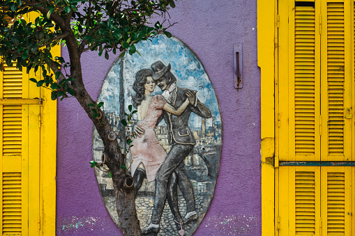 Colourful facade in the very colourful quarter La Boca in Buenos Aires, Argentina, South America. Painting on a wall resembling two people dancing the tango