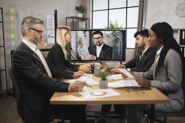istock Confident bearded Caucasian man tells business program concept to his multinational colleagues 1392343650