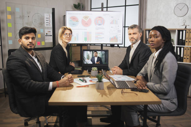 istock Skillful businesspeople looking at the camera while having video conference from laptop in boardroom 1392344017